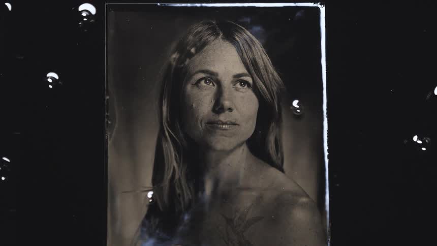 Photograph of a woman becoming clear as it develops in the liquid solution