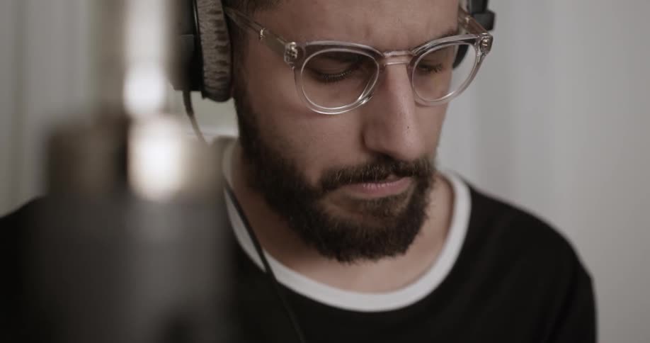 A musician is bobbing his head with headphones