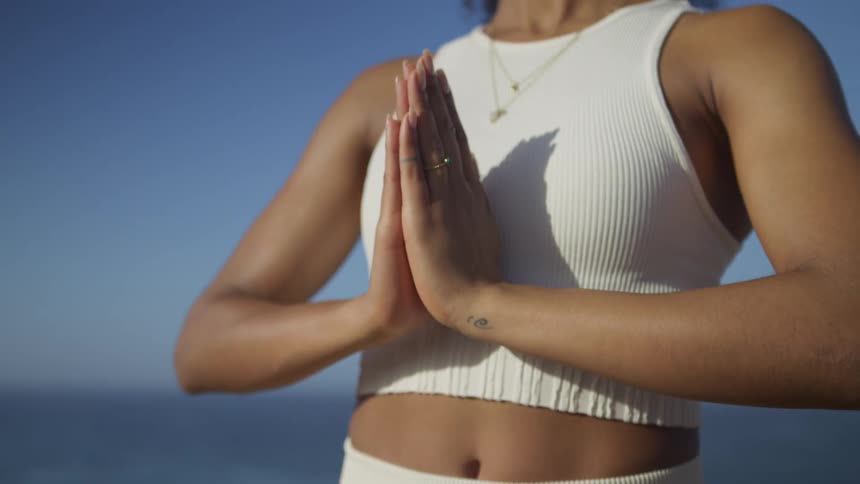 Yoga practice with hands joined in a prayer position outdoors