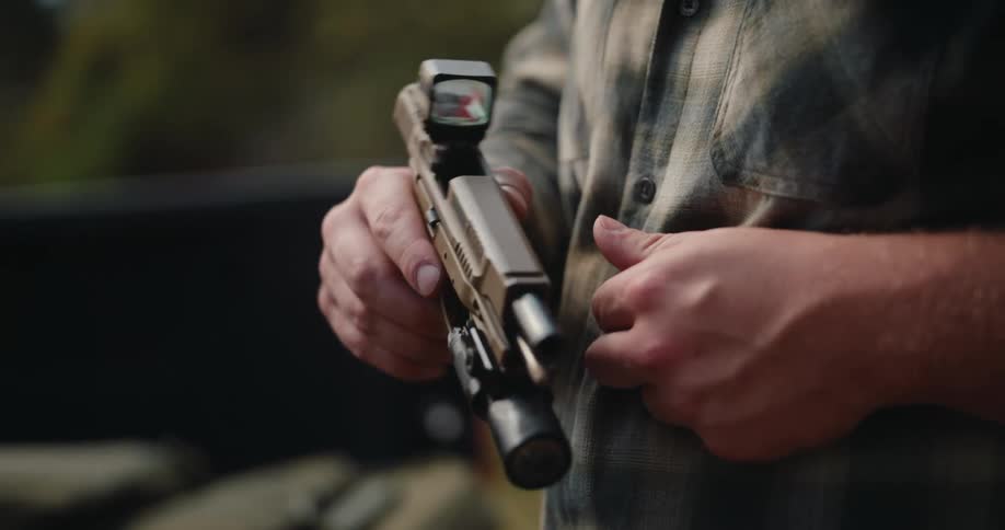 Pair of hands handling a customized pistol