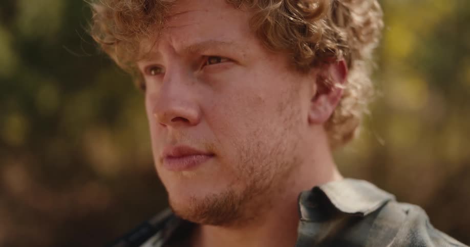 Curlyhaired man outdoors