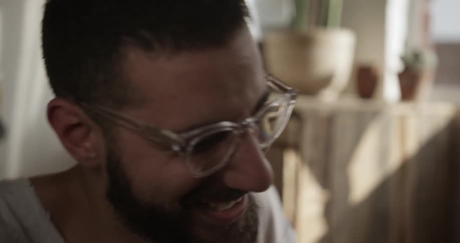 A man looks down playing guitar