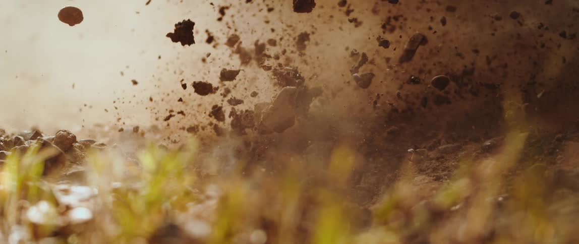 A close up of some soil exploding