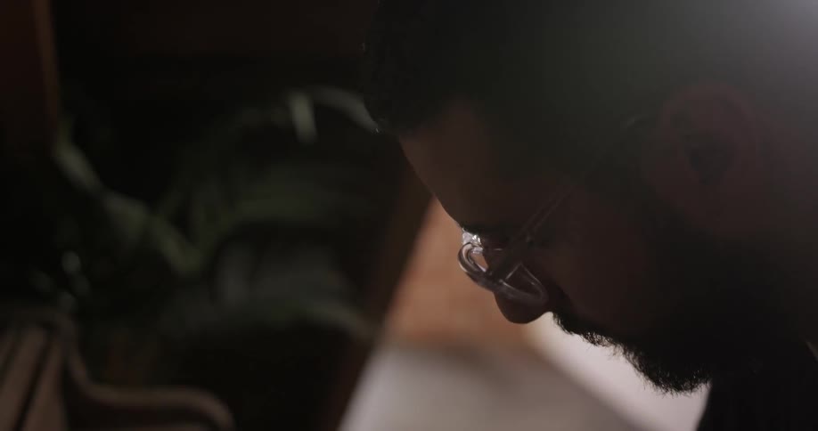 Bearded man looking down and studying something