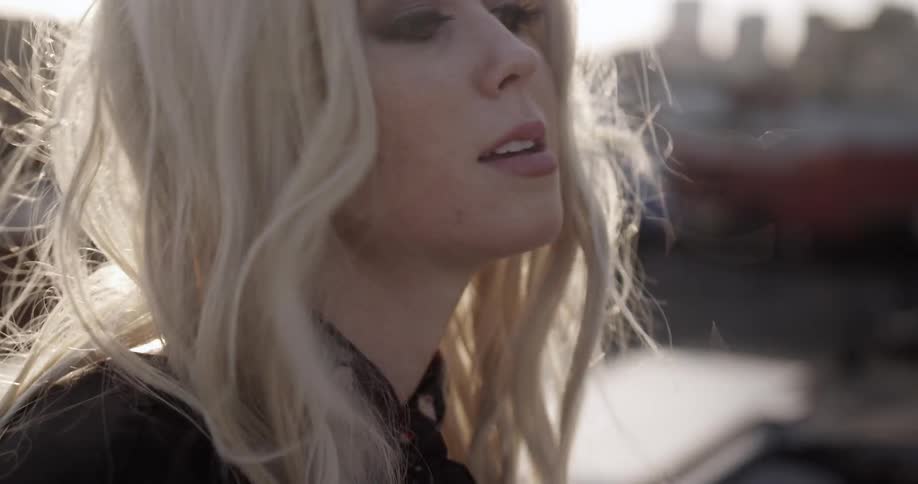 A woman is singing on a windy day