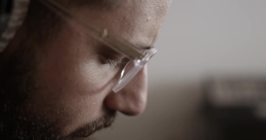 A man is looking down talking