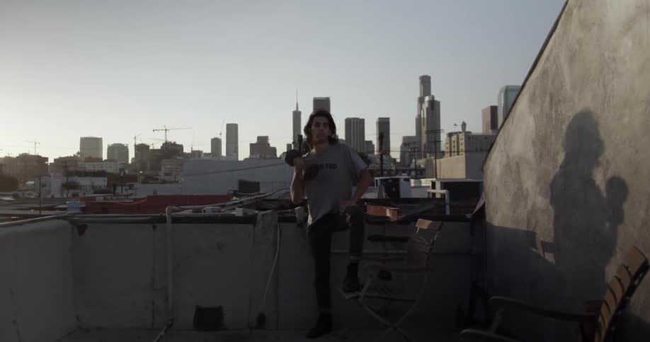A man is lifting weights on the roof