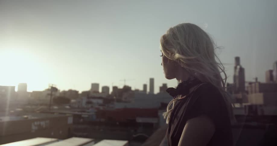 A woman looks out over a city