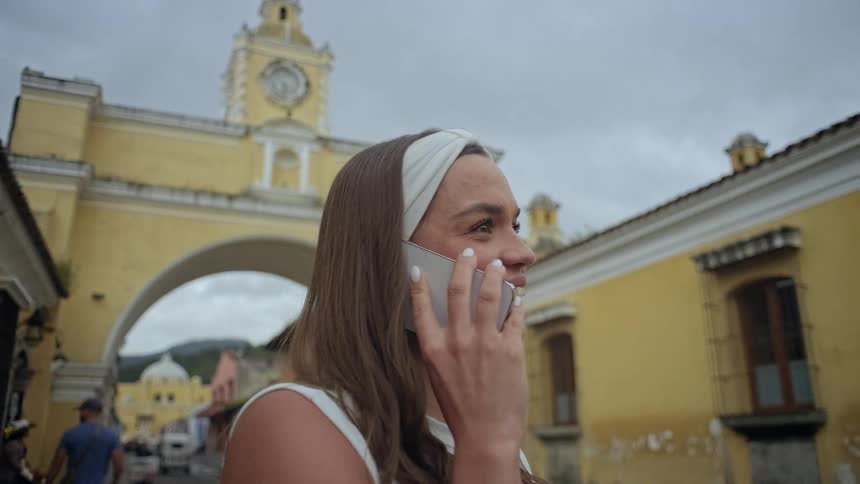 Woman happily chatting on her cell phone