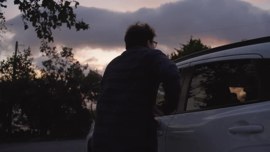 A man gets out of his car