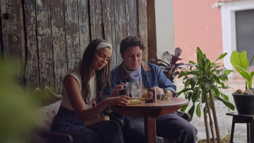 A man and woman having food at a table