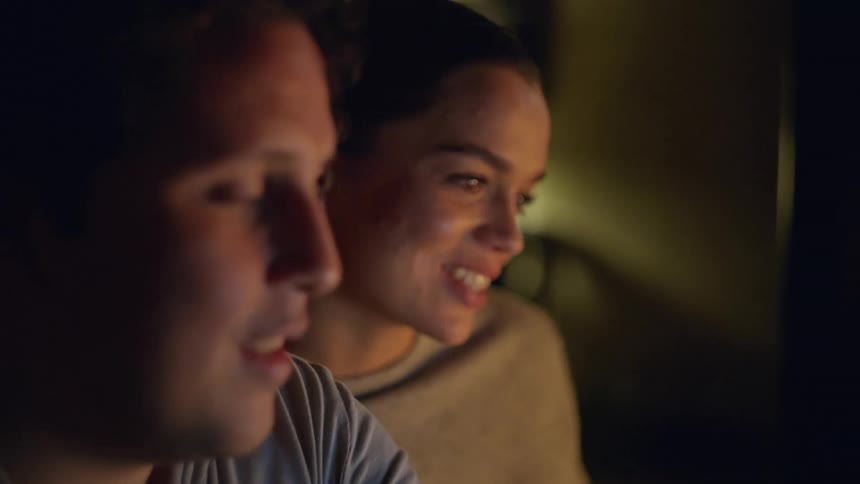 Two friends nod and smile while talking