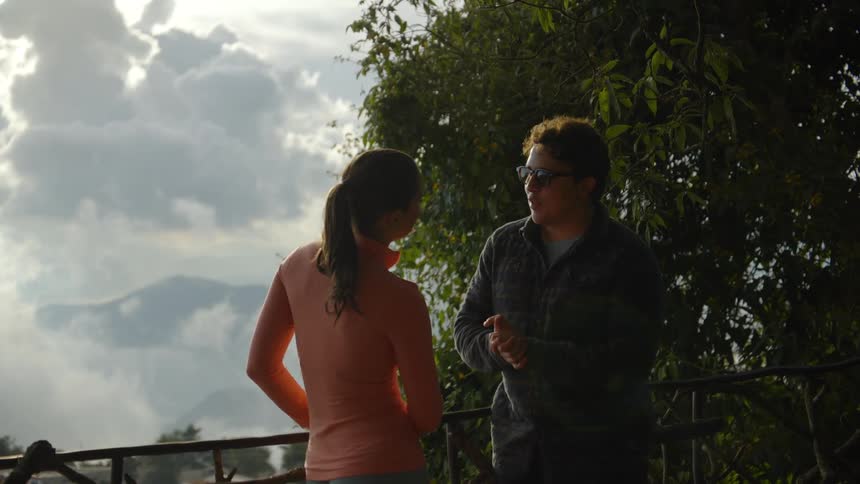 A man and woman standing outside