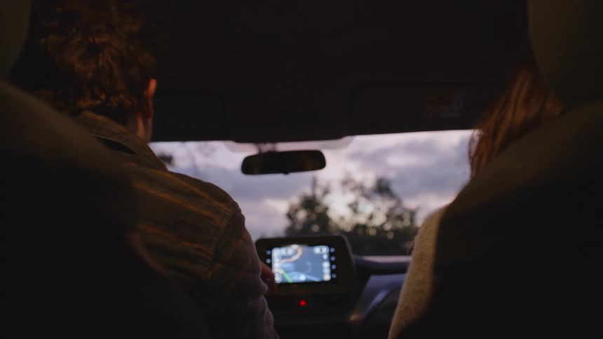 The man and woman high five in the car