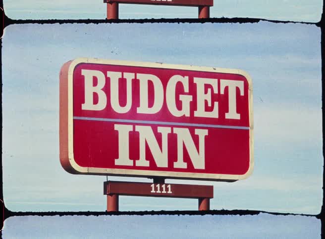 Budget inn hotel sign against a blue sky