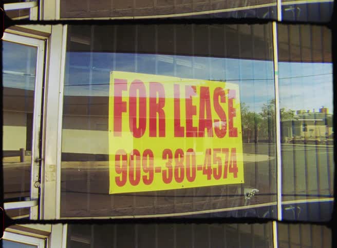 Sign with text in numbers on the glass wall of an establishment