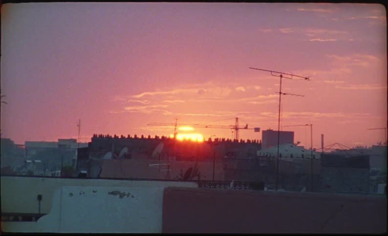 Panorama of an urban neighborhood with the sunrise on the horizon