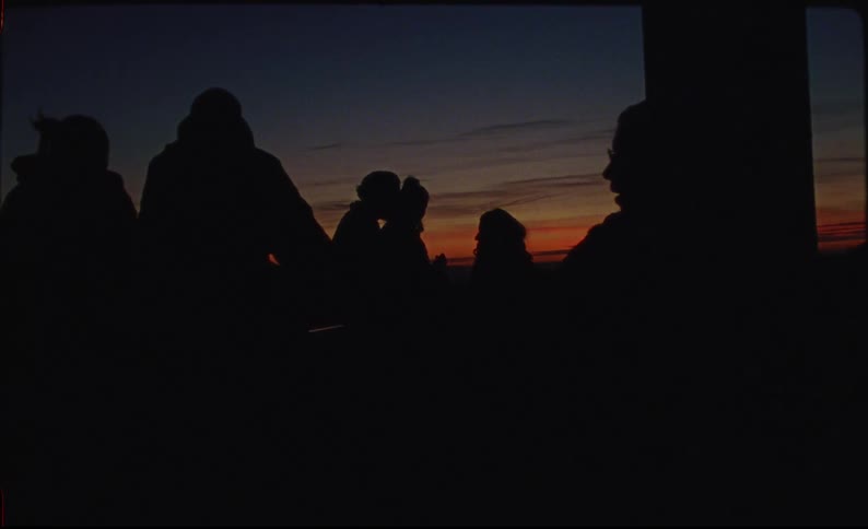 A group of friends gathering outside a tourist area in the evening