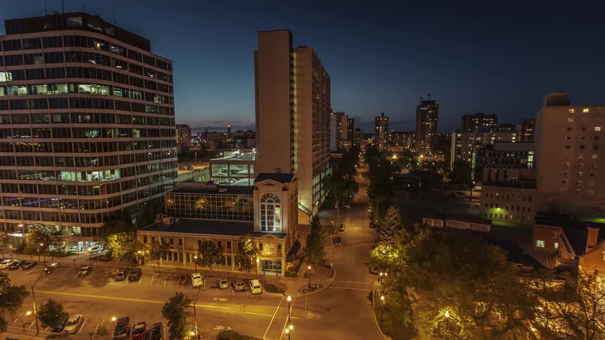 Cars drive on a city street at night