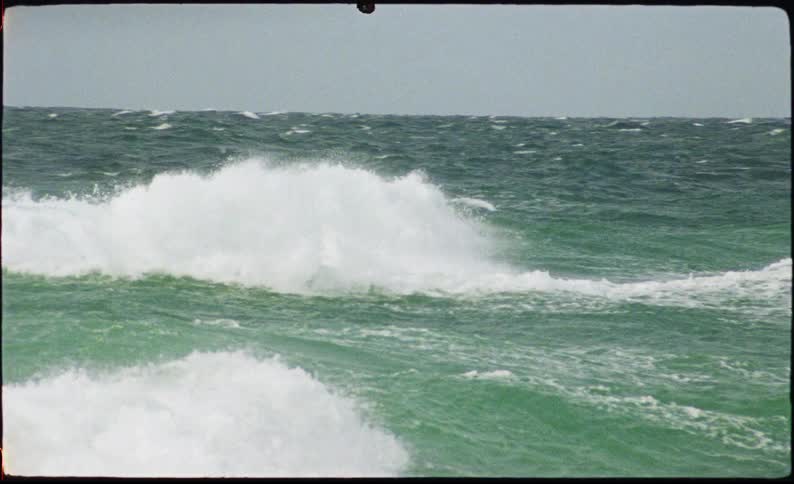 Moving waves on a greenish sea