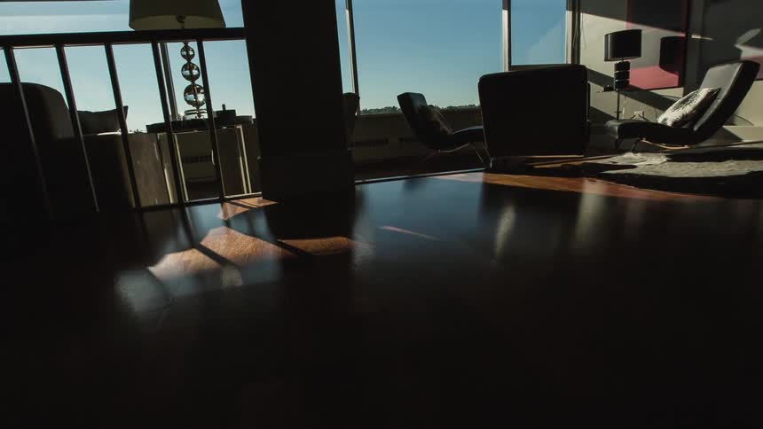 The dark room has furniture and a wall window