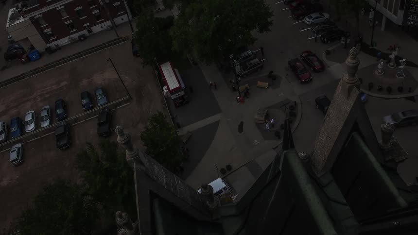 Cars move fast around this intersection as night comes