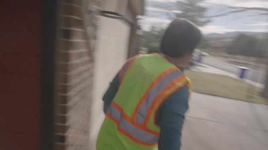 A delivery driver dropping off a package