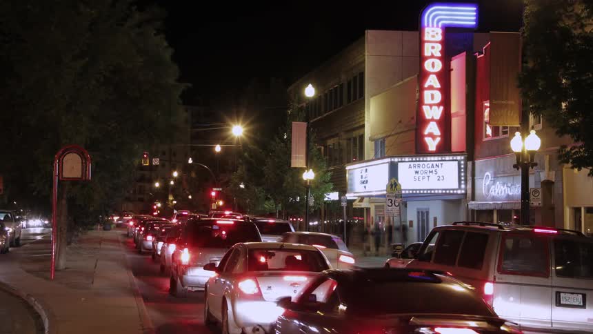 Traffic speeds through a city at night
