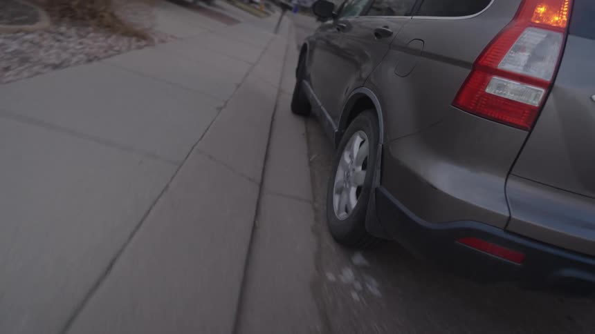 The van pulls up and parks by the sidewalk
