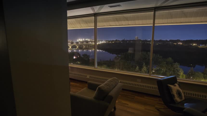 A fireplace is going in a living room at dawn
