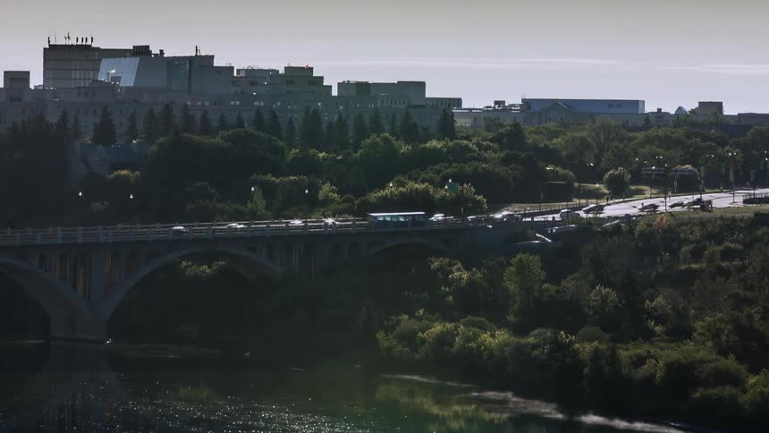 Urban traffic crossing a bridge while water flows in the river below