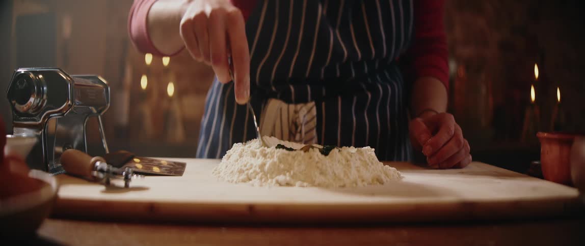 A person mixing food in flour