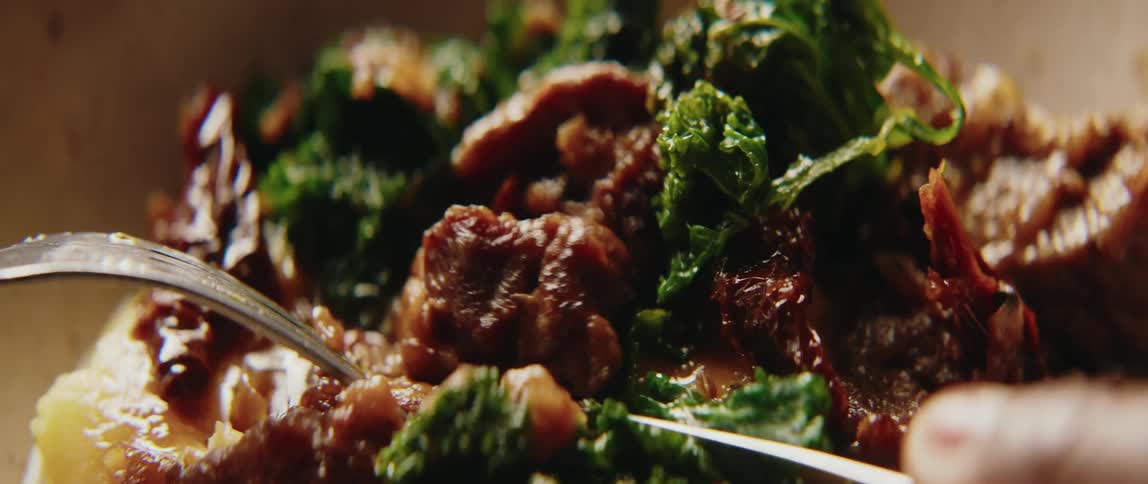 Person slices a piece of the meat in an entree