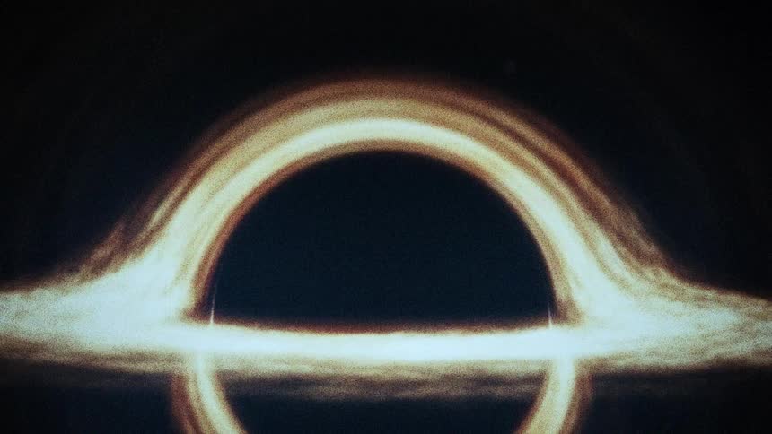 A dark hole in dark space with bright lights around it