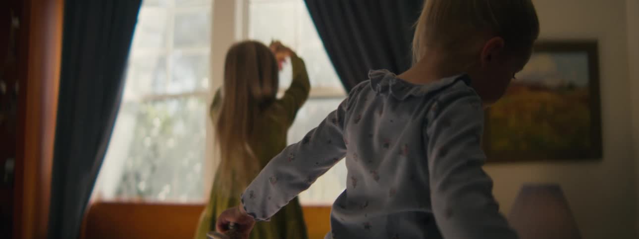 The two girls are playing with toys and walking around