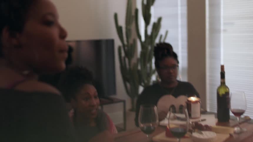 Women talk and sit around a table