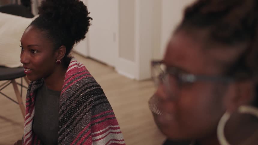 A woman talks to people smiling