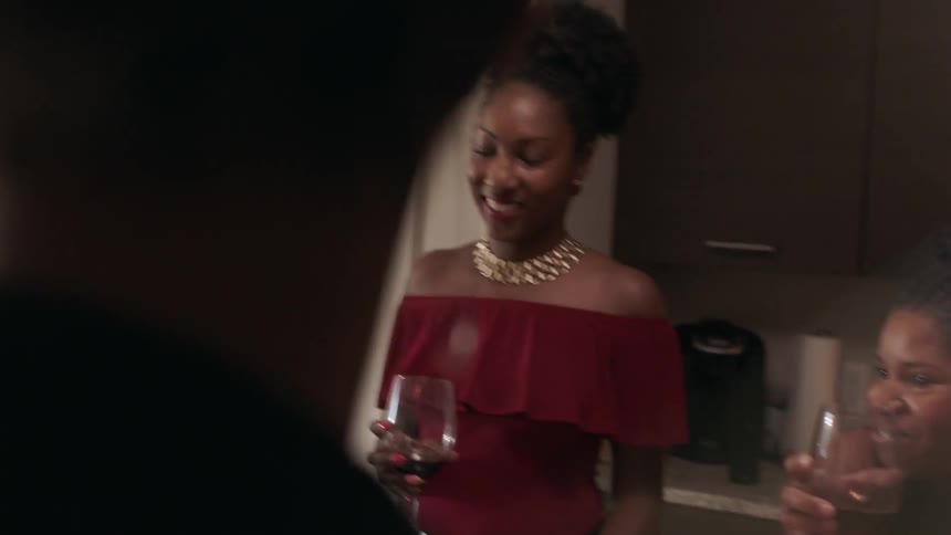The women smile and talk at this dinner party
