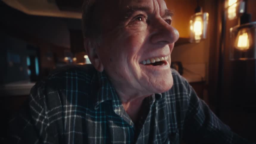 The man is happy while using a calculator and laptop