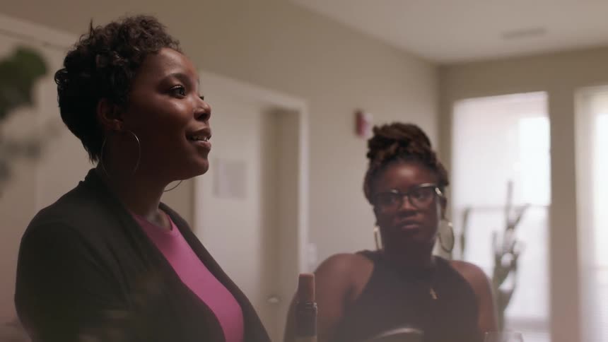 Women chat in a kitchen