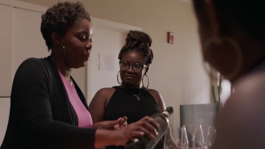 Women sit around a table talking