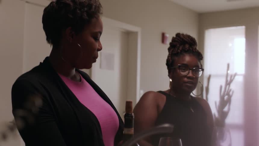 Women talk together around a table