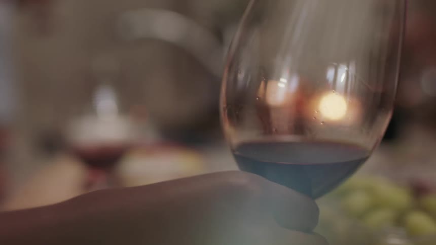Person twirling wine in wine glass