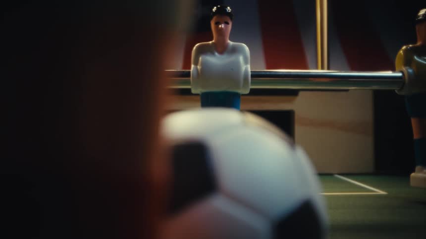 Toy ball positioned on a foosball table