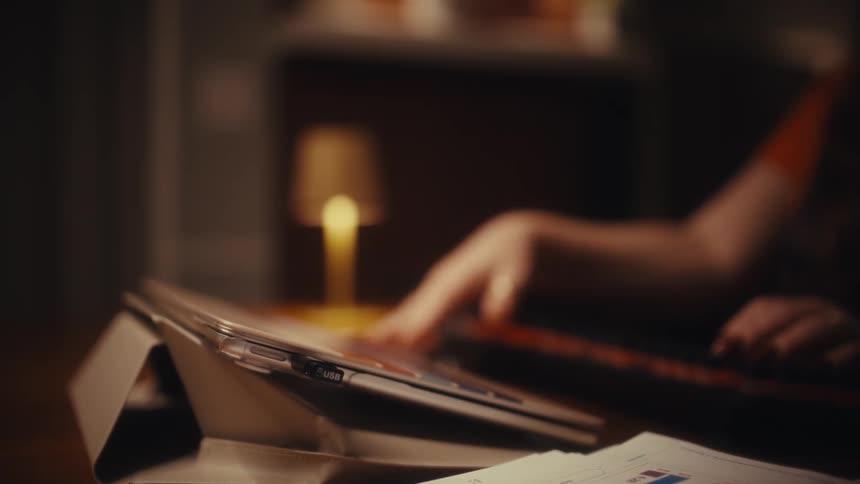 Person typing and closing a laptop
