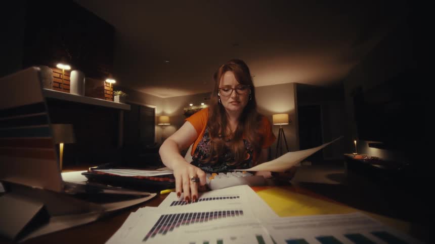 Woman sitting at a table and working with documents