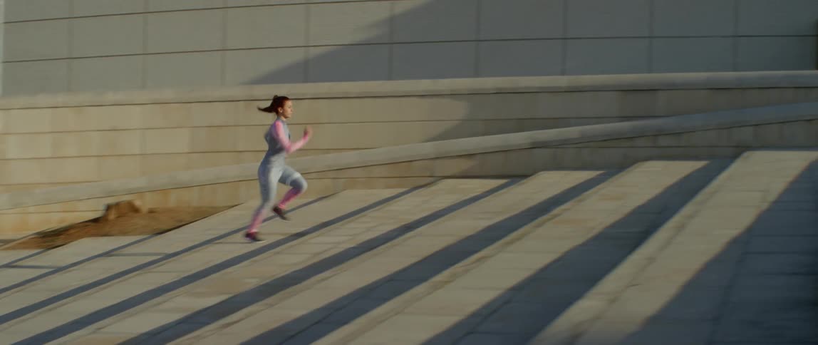 Woman jogging up concrete stairs