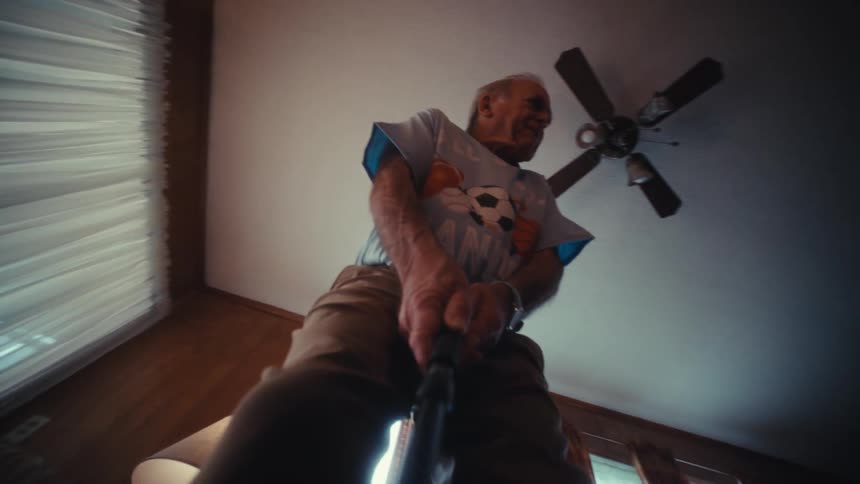 An elderly man celebrates after taking a golf shot