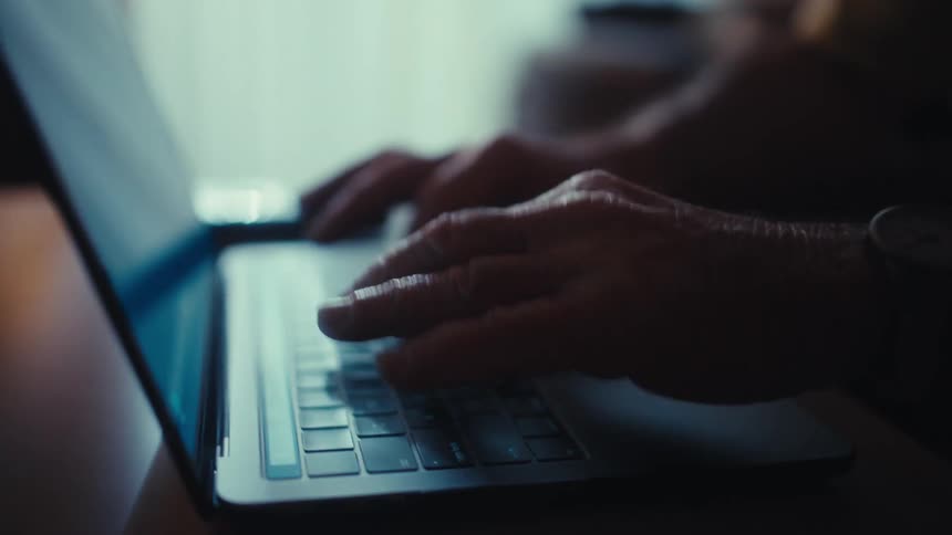 A person typing on a laptop