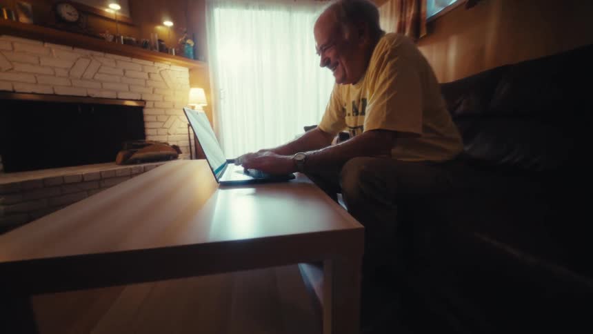 A man types on a laptop
